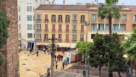 Malaga-Spain-old-town-rainy-day,-palm-trees-and-historical-buildings