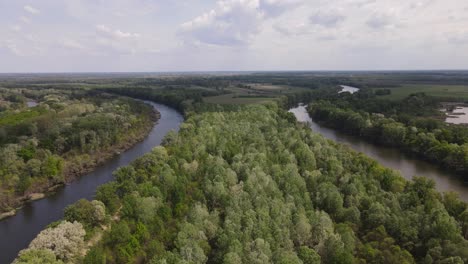 Aerial-view-over-section-of-Tisza-River-in-Hungary-winding-through-forest