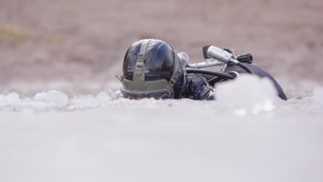 Head-of-man-with-full-face-scuba-dive-mask-pops-up-from-icy-lake-water