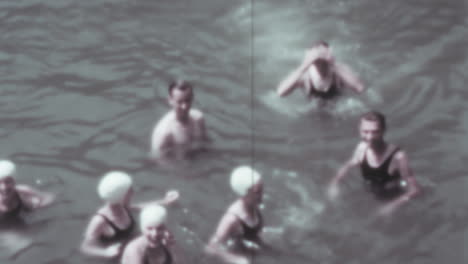Man-Runs-and-Dives-Into-the-Pool-with-Friends-on-a-Sunny-Summer-Day-of-1930s