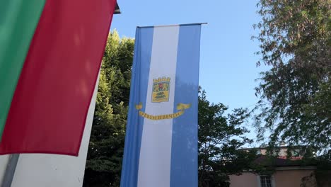 Traveling-shot-of-the-hanging-flags-of-Bulgaria,-the-European-Union,-and-the-city-of-Plovdiv