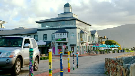 Colorful-Hermanus-CBD-with-street-art-and-clock-tower-on-waterfront,-static