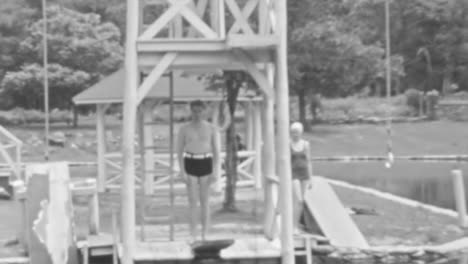 Man-Jumps-on-Trampoline-Straight-into-the-Lake-in-Summer-Day-of-1930s