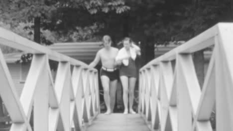 Man-and-Woman-Enjoy-a-Walk-on-Wooden-Bridge-in-the-Tranquil-Setting-of-a-Forest