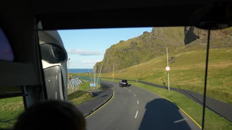 Sightseeing-and-Landscape-of-Heimaey-Island,-Iceland,-Bus-on-Countryside-Road-on-Sunny-Winter-Day,-Driver's-POV,-Slow-Motion