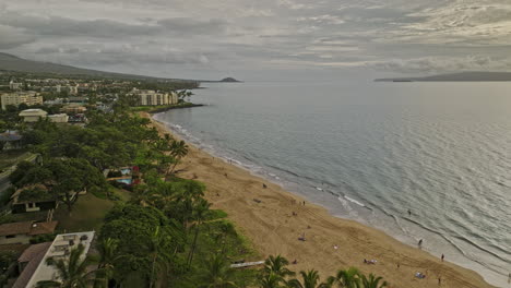 Kihei-Maui-Hawaii-Aerial-v3-drone-flyover-scenic-Kamaole-Beach-Park-towards-Wailea-capturing-golden-sandy-beach,-calm-waters-and-seaside-condos-at-sunset---Shot-with-Mavic-3-Cine---December-2022