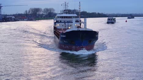 The-Rix-Union-Cargo-Vessel-Navigating-Along-the-River-in-Zwijndrecht,-Netherlands---Wide-Shot