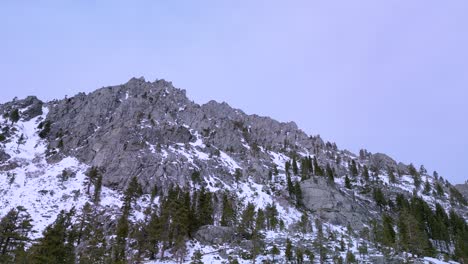 Desolation-wilderness-snow-covered-mountain-rock-face,-Lake-Tahoe,-California,-Aerial-Drone