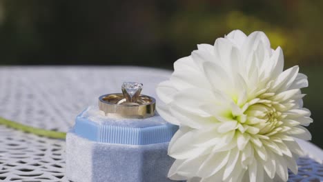 Wedding-flower-set-next-to-wedding-ring
