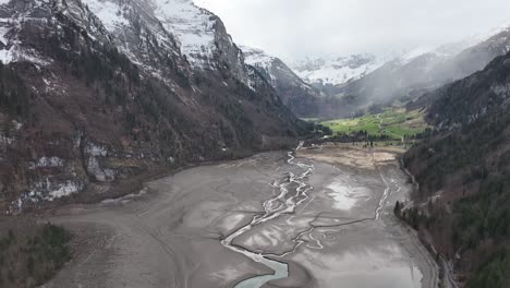 Aerial-view-of-the-Klöntalersee-area-with-Vorder-Glärnisch-mountain,-Glarus,-Switzerland