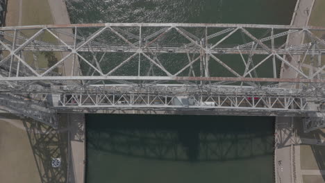 Slow-Motion-Aerial-Shot-of-Traffic-Crossing-Duluth's-Lift-Bridge