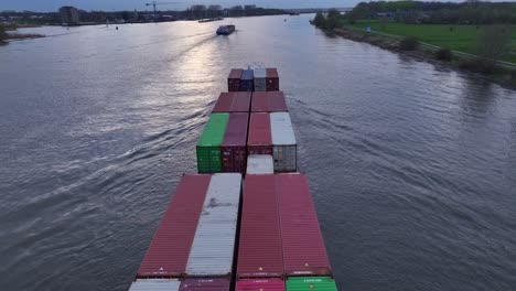 The-Virage-Cargo-Vessel-Sailing-Along-the-River-in-Zwijndrecht,-Netherlands---Aerial-Drone-Shot