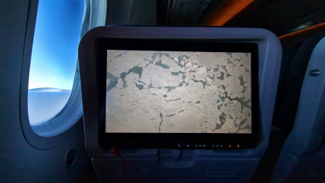 View-of-the-ground-below-the-airplane-during-the-flight-on-a-monitor-display