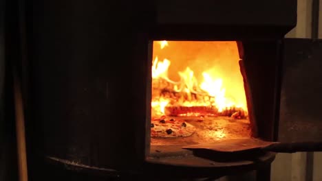 Wood-is-burning-in-a-pizza-oven