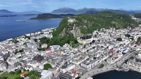 Drone-Shot-of-Picturesque-Alesund-Norway-on-Sunny-Summer-Day,-City-Buildings,-Green-Hill-and-Islands-All-Over-Bay-60fps