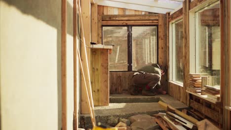 Greenhouse-Interior-Renovation---Man-Marking-Measurement-On-Floor