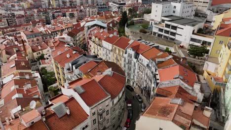Drone-shooting-and-turning-to-the-left-over-a-curvy-street-in-Lisbon