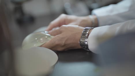 Doctor-Holding-and-Showing-Silicone-Breast-Prosthesis