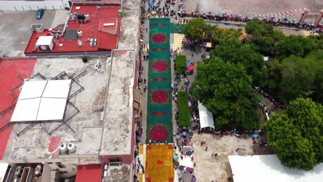 Drone-shot-of-the-colourful-artistic-sawdust-carpets-in-Huajuapan-de-Leon,-Oaxaca,-Mexico-during-their-annual-celebration-on-July