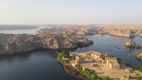 An-aerial-perspective-captures-the-Philae-temple-complex,-nestled-on-an-island-within-the-reservoir-created-by-the-Aswan-Low-Dam,-downstream-of-the-Aswan-Dam-and-Lake-Nasser,-in-Egypt