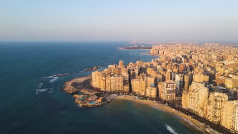Aerial-view-showcases-the-coastal-residential-district-of-Alexandria,-a-Mediterranean-port-city-in-Egypt,-embodying-the-concept-of-seaside-living-and-maritime-charm