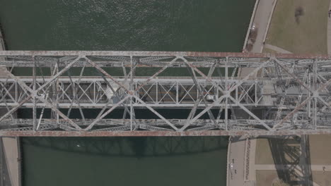 Top-Down-Aerial-View-of-Cars-Driving-on-Aerial-Lift-Bridge-in-Duluth