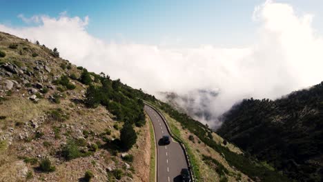 Drone-Shot-of-Moving-Car-on-Scenic-Curvy-Road,-Inversion-on-Sunny-Day,-Drone-of-Madeira