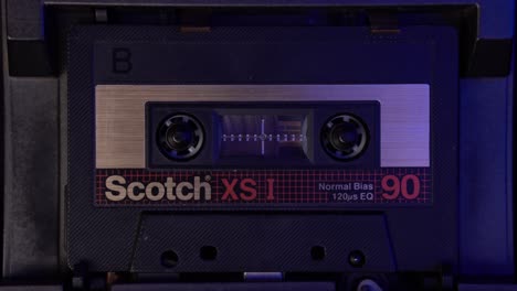 Scotch-Audio-Cassette-Tape-Playback-in-Vintage-Deck-Player-From-1980's,-Close-Up