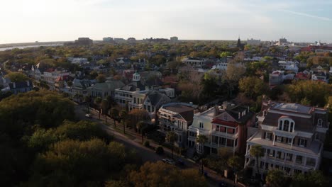 Dolly-panning-aerial-shot-of-antebellum-mansions-at-Oyster-Point-during-sunset-in-Charleston,-South-Carolina