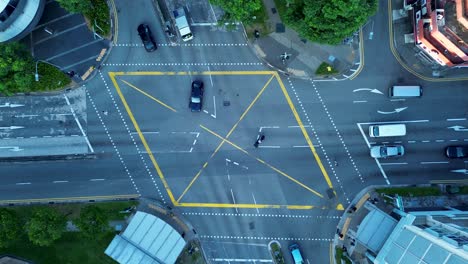 Aerial-drone-bird's-eye-view-of-traffic-cars-on-motorway-road-busy-street-with-roundabout-intersection-lights-Farrer-Park-Singapore-Asia-transportation