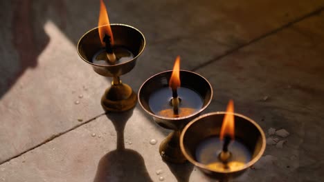 Butter-lamps-burning-in-the-Boudhanath-Temple,-Kathmandu,-Nepal