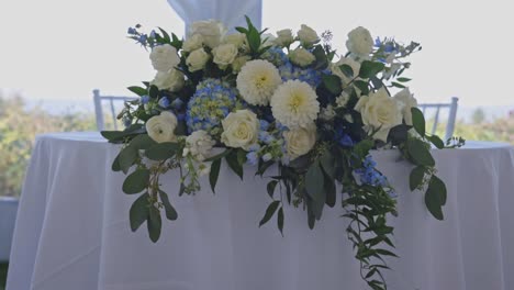 Flowers-sit-at-table-during-wedding-reception