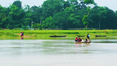 Serene-Scenery-Of-Villager-People-Crossing-River-By-The-Boat-In-Rural-Landscape-Of-Bangladesh