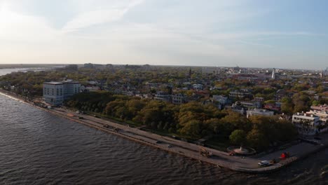 Aerial-dolly-panning-shot-of-White-Point-Garden-along-the-South-Battery-seawall-during-sunset-in-Charleston,-South-Carolina