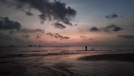 Romantic-mood-of-two-embracing-lovers-in-the-sea-on-the-coast