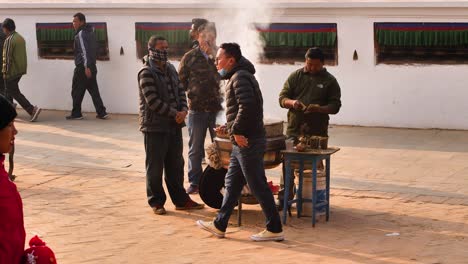 Large-pot-of-burning-incense-on-the-outer-section-of-Boudhanath-Temple,-Kathmandu,-Nepal