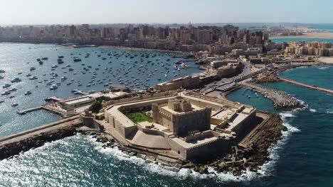 Aerial-of-the-Citadel-of-Qaitbay,-a-15th-century-defensive-fortress-perched-on-the-Mediterranean-coast-in-Alexandria,-Egypt,-the-concept-of-historical-resilience-and-maritime-protection