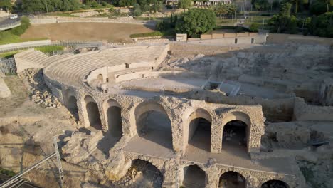 Drone-starts-at-old-Roman-Colosseum-and-pulls-back-over-Mediterranian-to-reveal-the-town-of-Tarragona-in-Spain
