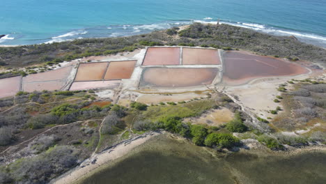 Aerial-backwards-shot-of-salt-extraction-Area-near-Caribbean-sea-in-San-Fernando-de-Monte-Cristi,-Dominican-Republic