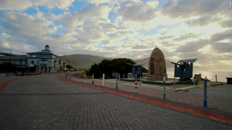 Epic-golden-clouds-at-sunrise-with-view-of-Hermanus-War-Memorial-and-Clock-Tower
