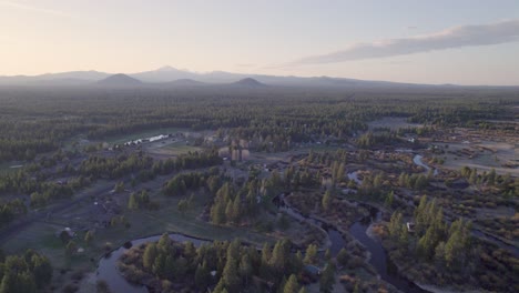 Ascending-drone-shot-captures-the-Three-Sisters-mountains-in-Bend,-Oregon