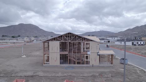 Drone-pulls-back-to-reveal-partially-built-house-on-a-cloudy-day