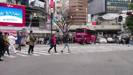 Pedestrians-Cross-On-The-Street-In-Shibuya-City,-Tokyo,-Japan
