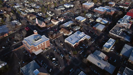 Downtown-Flagstaff,-Arizona-USA,-Aerial-View-of-Church,-Buildings-and-Street-Traffic-on-Winter-Day