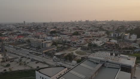 Drone-pans-right-to-reveal-sunset-over-Lagos,-Nigeria