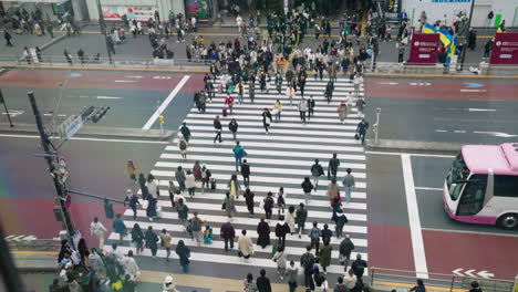 Pedestrians-Crossing-Near-Shinjuku-Expressway-Bus-Terminal-In-Shibuya-City,-Tokyo,-Japan