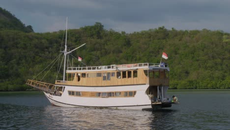 Small-tourist-boat-anchored-in-a-secluded-bay-near-Komodo-Island-in-Indonesia