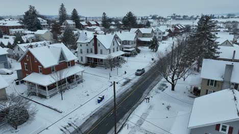 Snowy-residential-street-with-traditional-homes-and-snow-covered-trees