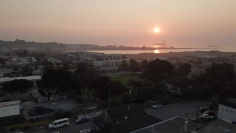 Drone-pushes-into-golden-sunrise-over-San-Francisco's-Bayview-neighborhood-with-light-fog