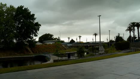 People-Walking-At-The-Quays,-Riverside-Park-Along-The-Taylor-River-On-Overcast-Day-In-Blenheim,-New-Zealand